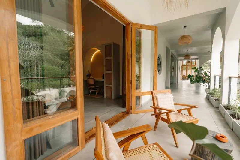 Cane lounge chairs on the balcony beside the room doors