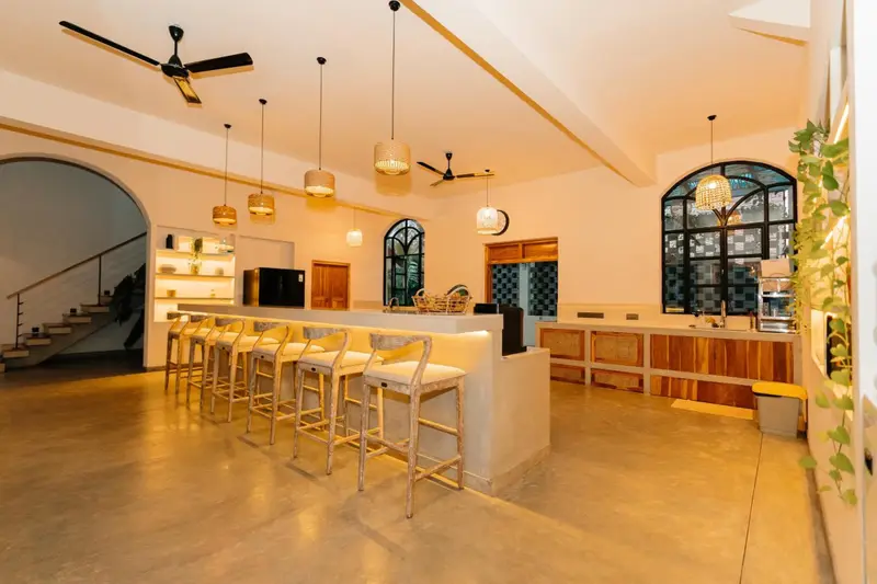 Bar counter with stools and backlit shelves