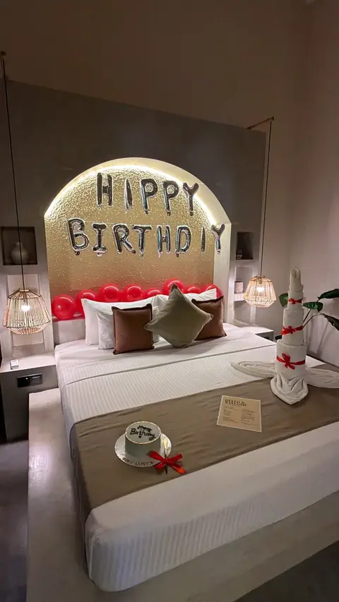 Room set up with a birthday balloon garland and flowers