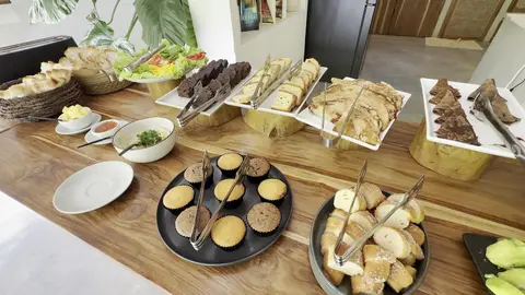 Breakfast buffet of breads, muffins and salads