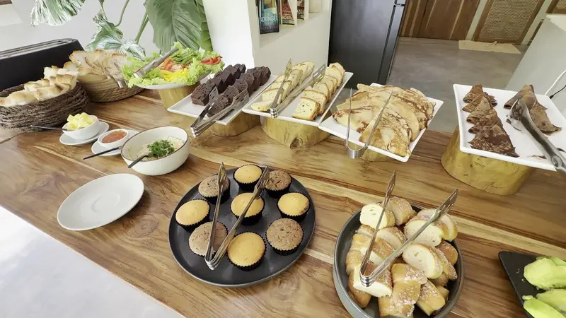 Breakfast buffet of breads, muffins and salads
