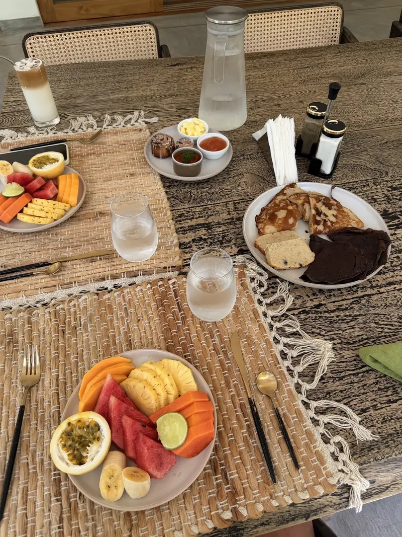 Breakfast of fruit, toast and eggs on a woven place mat