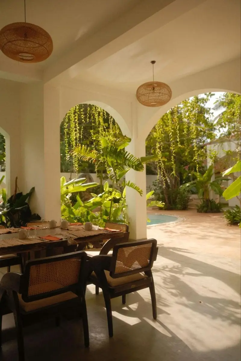 Dining terrace with cane chairs beside the garden