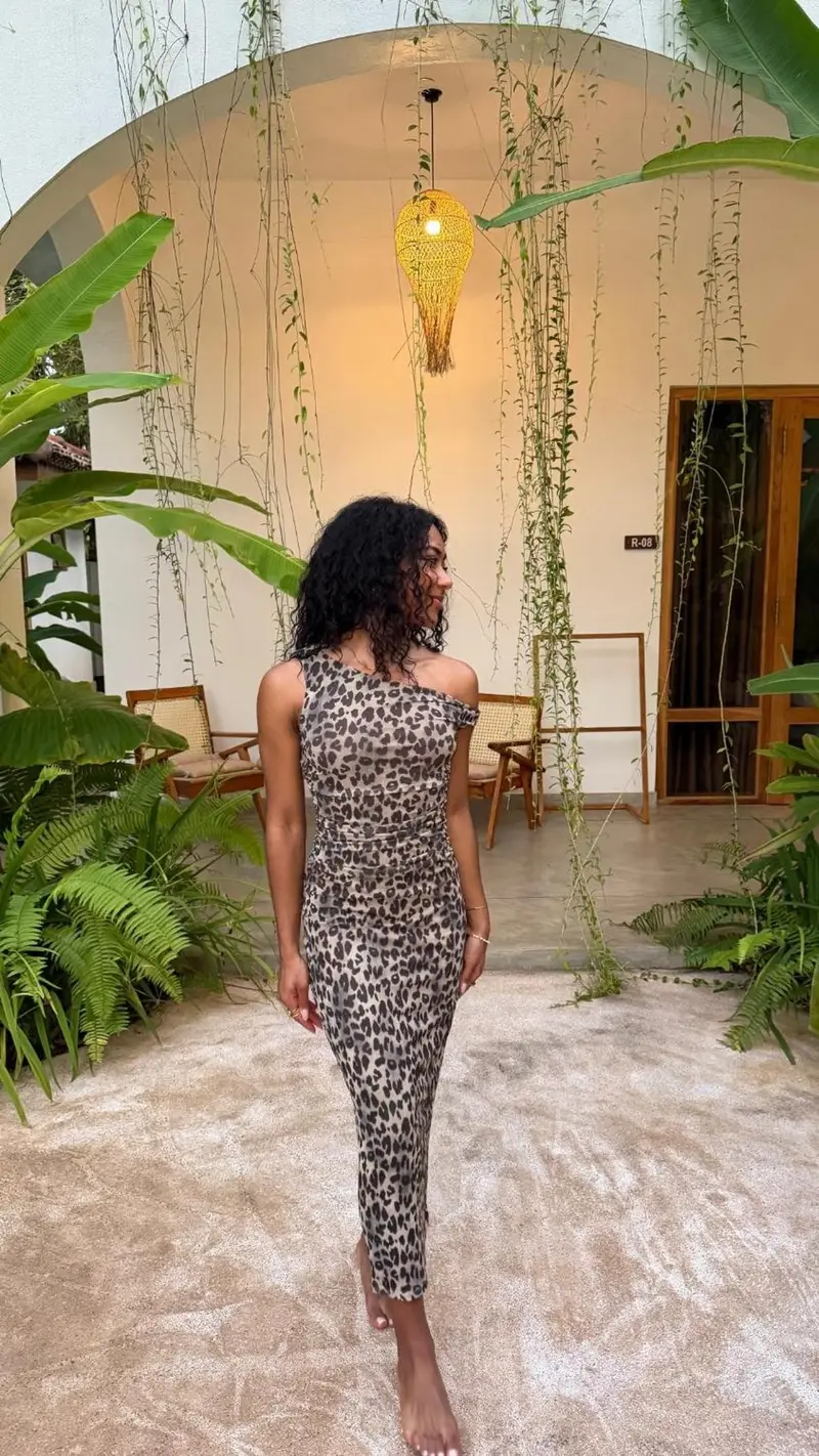 A guest posing under the arched veranda
