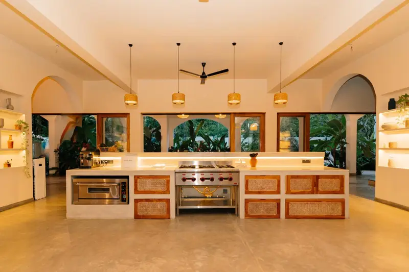 Open kitchen with island, arched windows and shelves