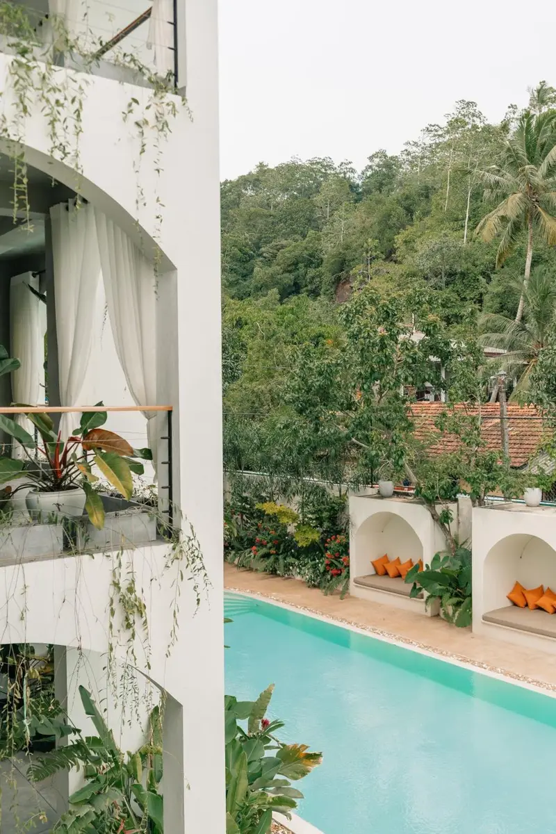 Looking down on the pool and cabanas from an upper balcony