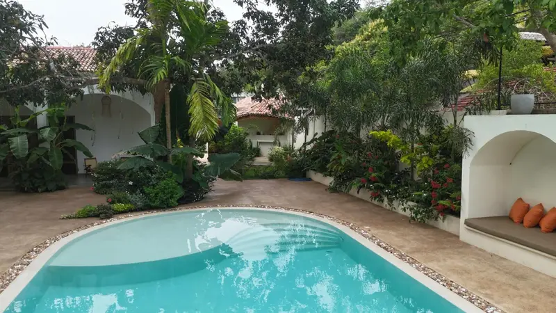 Lagoon-shaped shallow end of the pool beside a cabana
