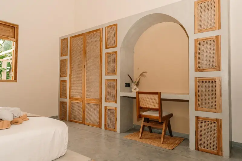 Writing desk and cane chair set into an arched alcove