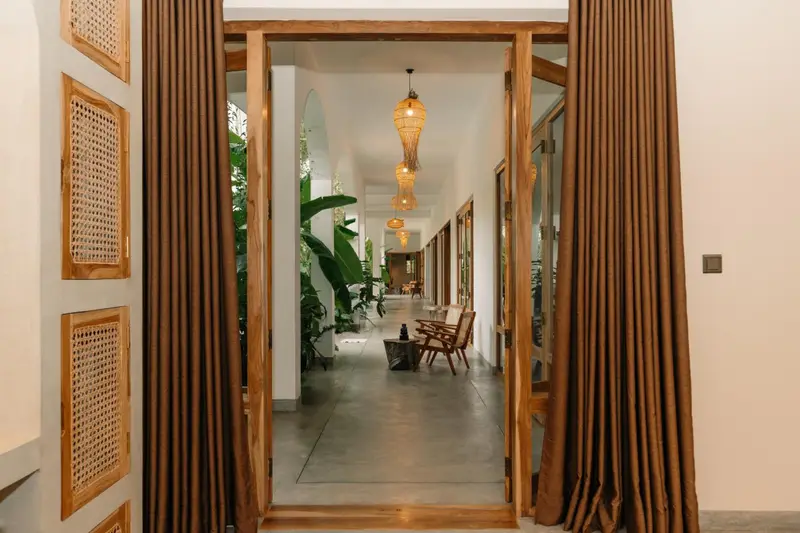 Teak doors open from the room to the veranda and garden