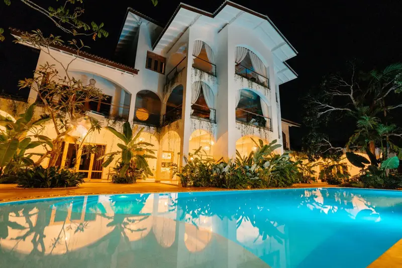 Oura Spirit villa and pool lit up after dark