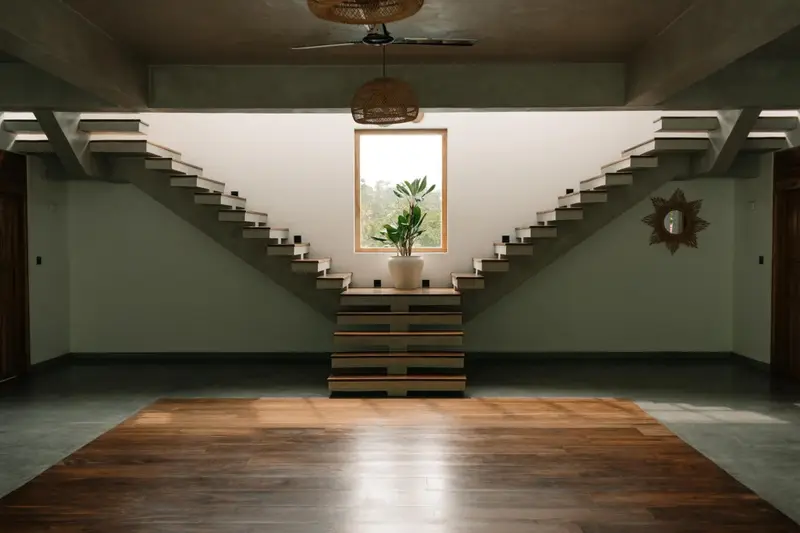 Yoga hall with timber floor and twin staircases